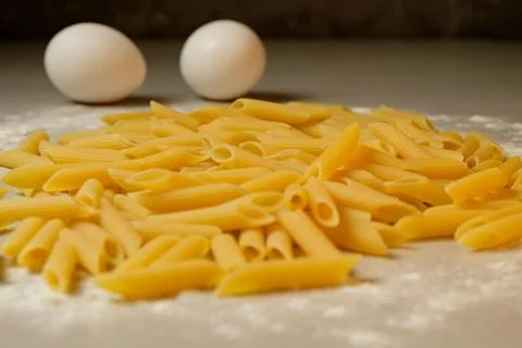 Pasta and eggs create a culinary masterpiece in a rustic kitchen setting Stock Photos