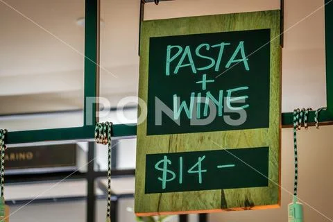 Pasta and wine for fourteen dollars sign Stock Photos