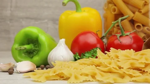 Pasta on background of fresh vegetables and spices Stock Footage 72141616