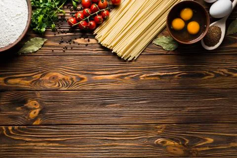 Pasta background. Several types of dry pasta with vegetables and herbs 스톡 사진