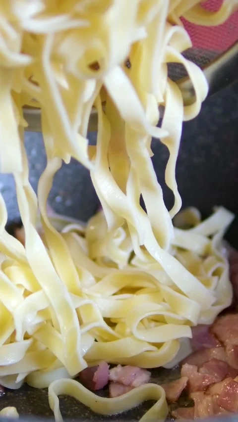 Pasta bacon cooking chef roasts cubes of bacon or Italian pork guanciale or Stock Footage 306936220