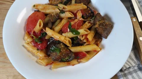 Pasta with baked eggplants, tomatoes, fresh basil and grated cheese Stock Footage 345669507