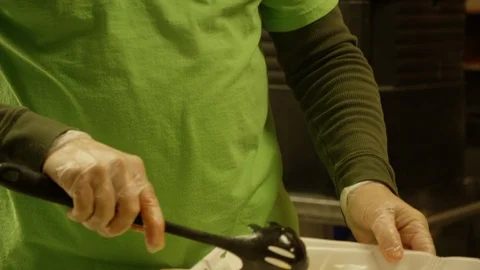 Pasta being spooned into tray in cafeteria or soup kitchen 1 Stock Footage 123784956