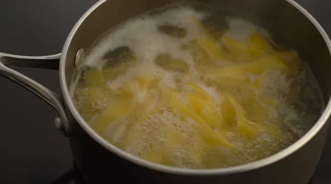 Pasta boiling in a pot on electric stove Stock Footage 67996624