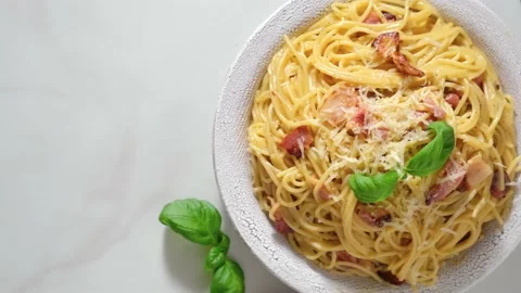 Pasta carbonara with bacon, cheese, basil and cream sauce with fork Stock Footage