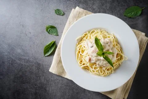 Pasta Carbonara with basil leaf  in white dish Stock Photos
