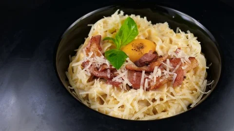 Pasta Carbonara with egg yolk, bacon, basil and parmesan cheese Stock Footage 80707555