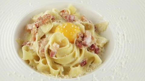 Pasta carbonara with parmesan, egg yolk and bacon Stock Footage 56428448