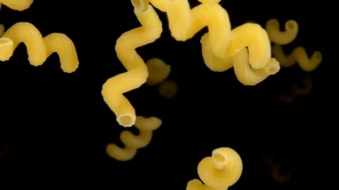Pasta cellentani bouncing against to the camera Stock Footage 75490649