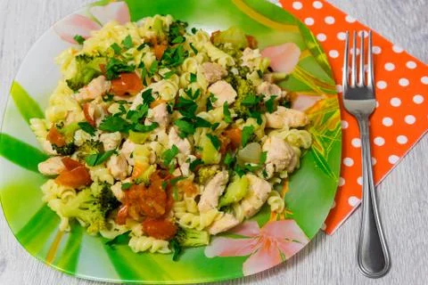 Pasta with chicken and broccoli on the table Stock Photos
