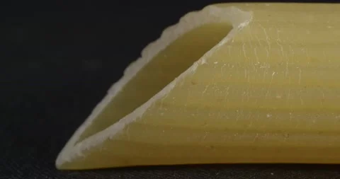 Pasta close-up on a black background. Macro food. Pasta feather. Stockbeeldmateriaal 166496196