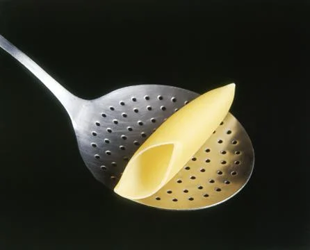 Pasta on a colander spoon Stock Photos