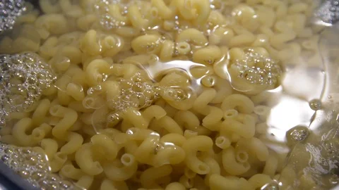 Pasta is cooked in a black cauldron close up, home made, Pasta cooked in a boili Stock Footage 101079654