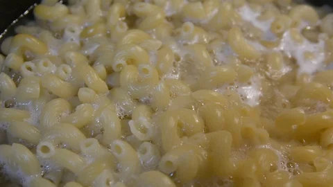 Pasta is cooked in a black cauldron close up, home made, Pasta cooked in a boili Stock-Footage 101080425