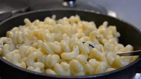 Pasta is cooked in a black cauldron close up, home made, Pasta cooked in a boili Stock-Footage 101080487