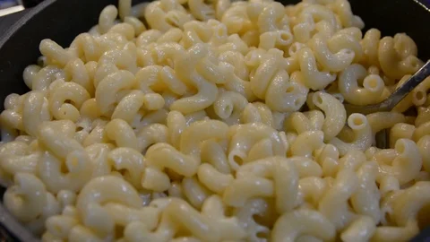 Pasta is cooked in a black cauldron close up, home made, Pasta cooked in a boili 動画素材 101081142