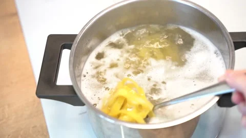 The pasta is cooked in boiling water in a saucepan Stock Footage 148552941