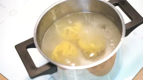 The pasta is cooked in boiling water in a saucepan Stock Footage 148552950