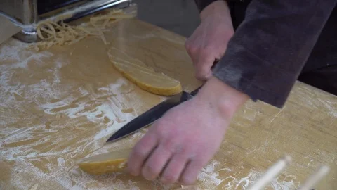 Pasta cutting machine for preparing fresh spaghetti, pasta coming out of pasta Stock Footage 106008177