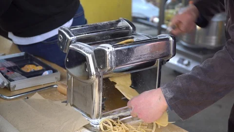 Pasta cutting machine for preparing fresh spaghetti, pasta coming out of pasta Stock Footage 106008178