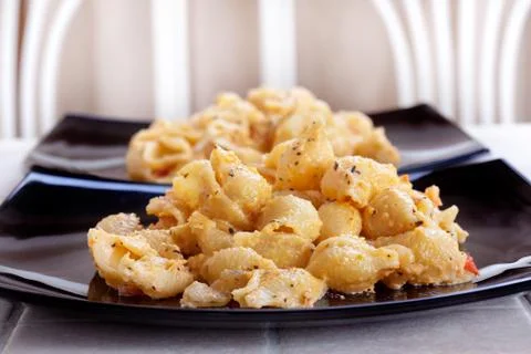 Pasta on a dark plate on the table Stock Photos