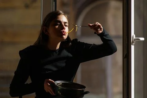 Pasta dinner with dramatic window lighting. Pasta lunch in a casual setting Stock Photos