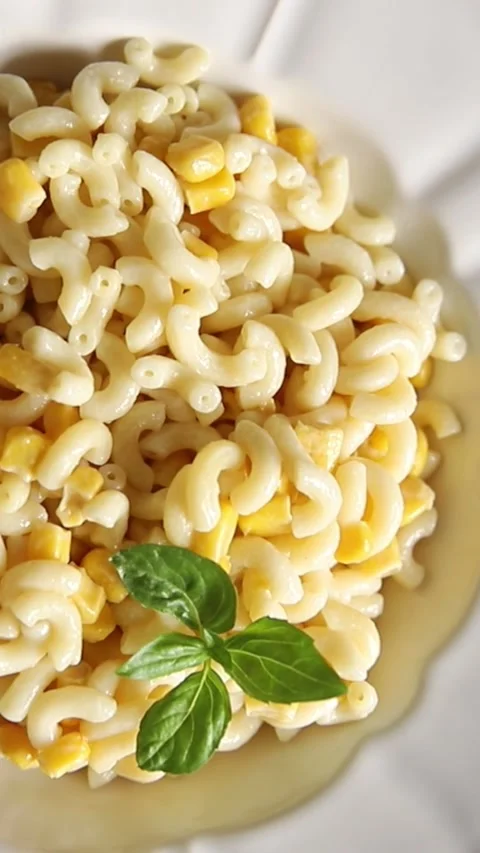 Pasta dish corn and creamy sauce small elbow macaroni small pasta shells Stock-Footage 344988682