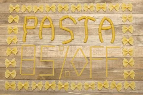 Pasta  eighty five percent off text made of raw pasta Stock Photos