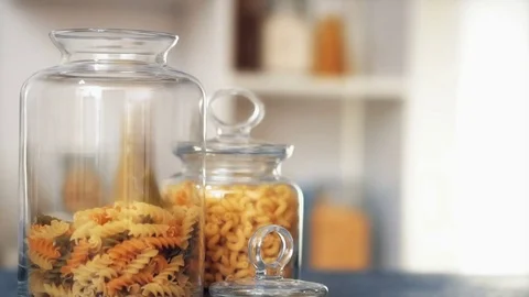 Pasta fall into a glass jar on white background Stock Footage 73238342