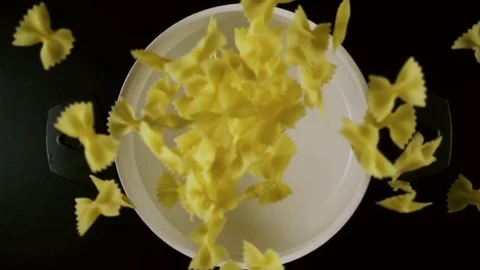 Pasta fall into a pot of water. Slow motion Stock Footage 74587809