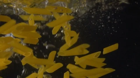 Pasta fall into the water on a black background Stock Footage 85274453