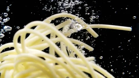 Pasta falling into the boiled water Stock Footage 130876936