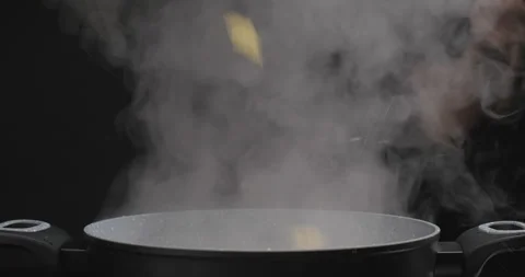 Boil water in a pot on dark background, Stock Video
