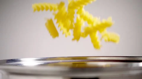 Pasta falling into saucepan, slow motion Stock Footage 55377820