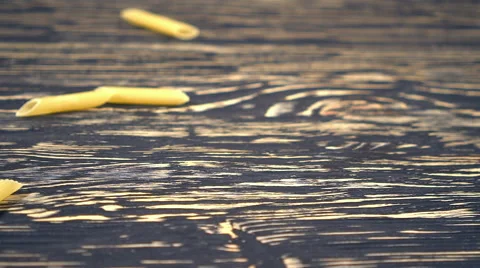 Pasta falling on the wooden background. Stock Footage 68639546