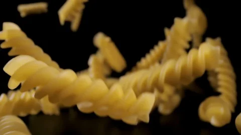 Pasta Fusilli Falling Down black background, slow motion Stock Footage 112442269