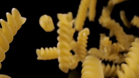 Pasta Fusilli Falling Down black background, slow motion Stock Footage 112444130