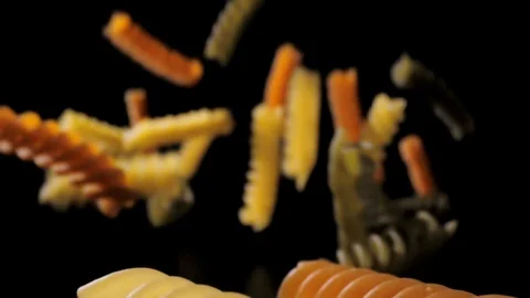 Pasta Fusilli Falling Down black background, slow motion Stock Footage 112444867