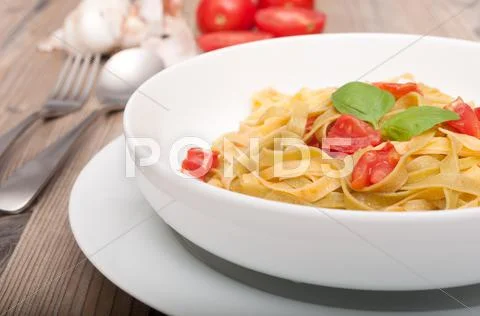 Pasta with garlic and tomatoes Stock Photos