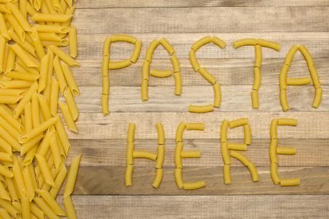 Pasta here text made of raw pasta Stock Photos