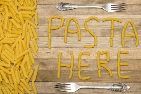 Pasta here text made of raw pasta Stock Photos