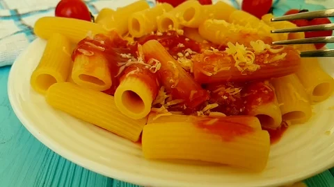 Pasta with ketchup, cheese cherry tomatoes, fork Stock Footage 89713073