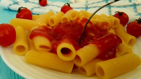 Pasta with ketchup, cherry tomatoes, fork Video stock 89712954