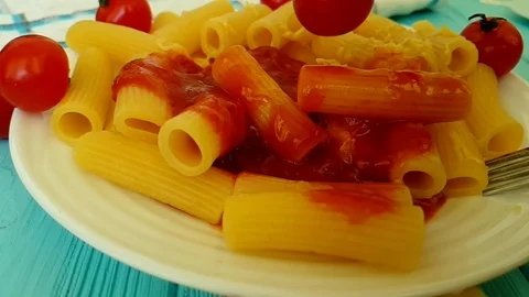 Pasta with ketchup, cherry tomatoes, fork, slow-motion shooting  hand Video stock 89712998