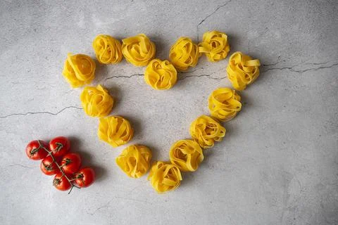 Pasta lie on the table in the shape of a big heart . 14 February Stock Photos