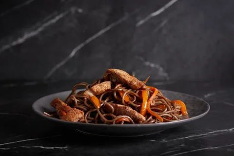 Pasta with meat, spaghetti, noodles, plate on a dark background, asian cuisine Stock Photos