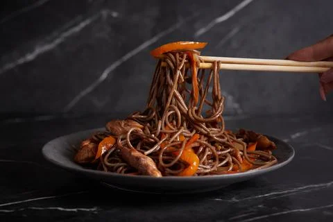 Pasta with meat, spaghetti, noodles, plate on a dark background, asian cuisine Stock Photos