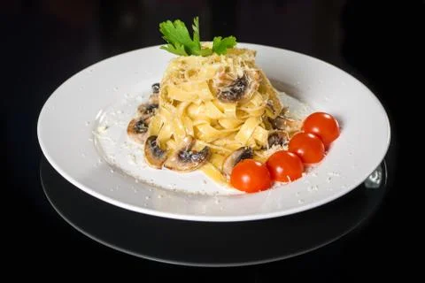 Pasta with mushrooms and tomato Stock Photos