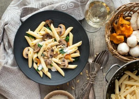 Pasta with mushrooms on rustic tabletop. Stock Photos