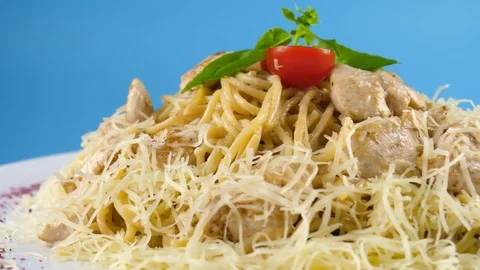 Pasta or Spaghetti with chicken and cheese, blue background ready for chroma key Stock Footage 78667022